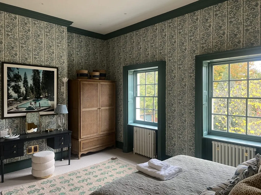 The same guest room from the bed, showing the paper carried across the reveals.